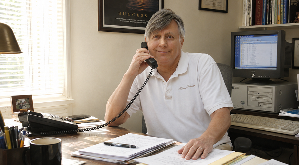 The founding ghostwriter in his office in 2002, talking with a client.